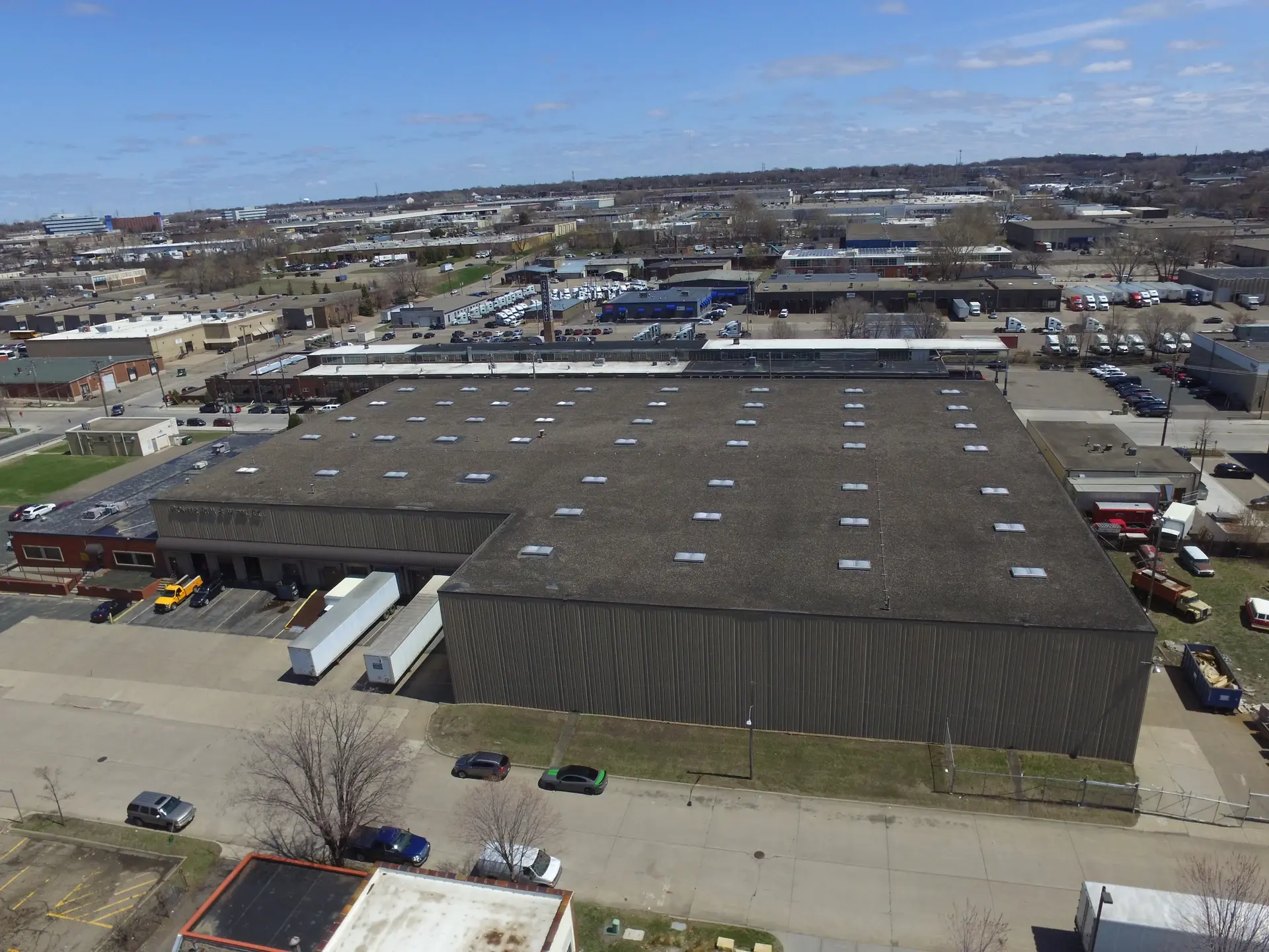 Aerial view of a flat commercial warehouse roof above a loading dock