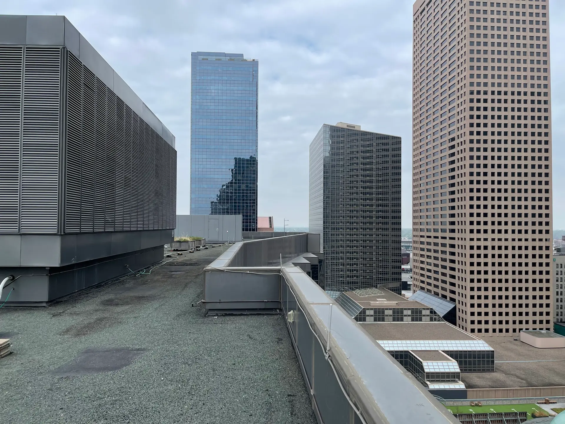 Gravel flat roof on a high-rise with downtown office towers behind